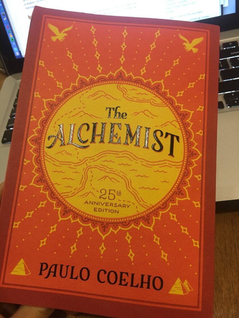 david smart holding the book the alchemist by paulo coelho